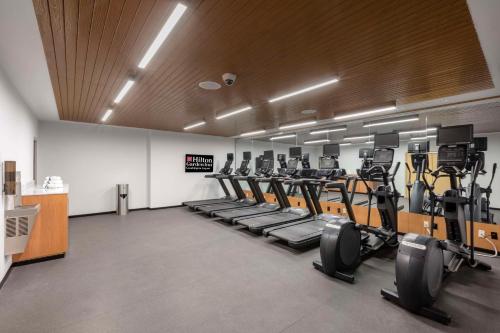 a gym with rows of treadmills and machines at Hilton Garden Inn Guadalajara Airport in Guadalajara