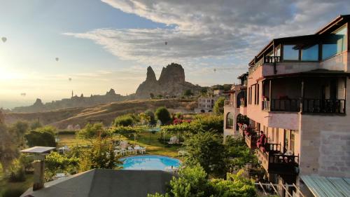 a view of a resort with mountains in the background at Karlık Evi Hotel - Special Category in Uchisar