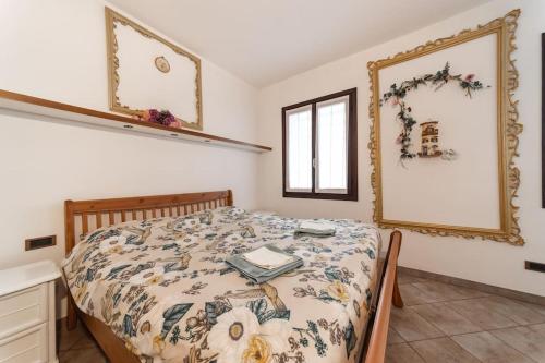 a bedroom with a bed and a mirror on the wall at Chalet nella roccia da Marinella in Taceno