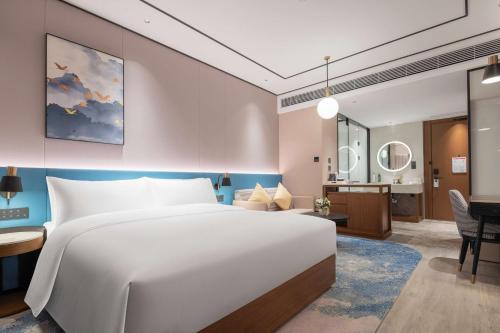 Ένα ή περισσότερα κρεβάτια σε δωμάτιο στο Hilton Garden Inn Yichang Yiling