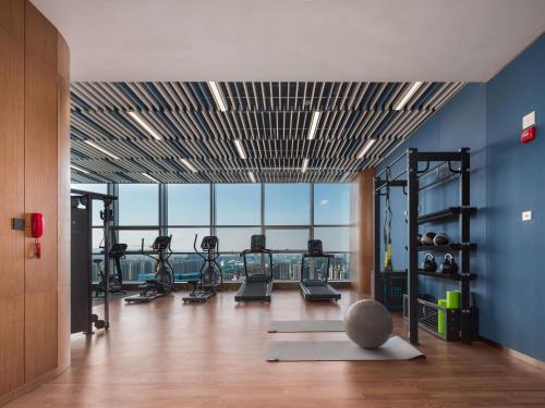 a gym with exercise equipment in a room with a view at Hilton Garden Inn Taiyuan Binhe in Yangjiabu