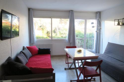 un salon avec un canapé et une table dans l'établissement Grand studio lumineux Boulouris, plage 5min à pied, à Saint-Raphaël