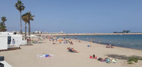 a group of people on a beach near the water at Apartamento Playa Bonita in Torrevieja