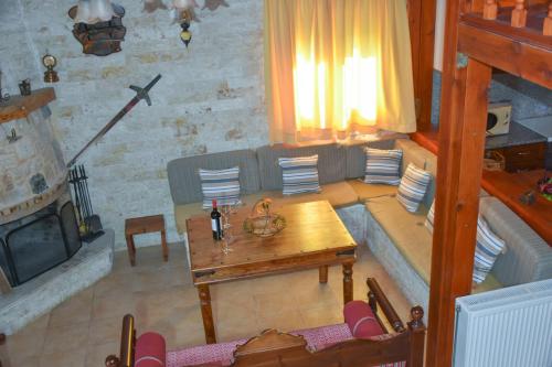 a living room with a couch and a table at Zaros Traditional House in Zarós