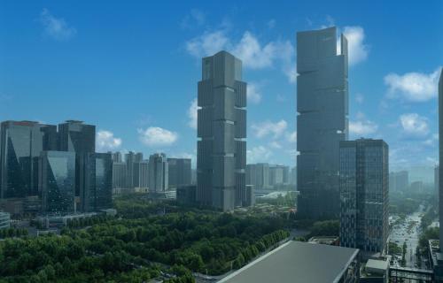 a view of a city with tall skyscrapers at Holiday Inn Express Zhengzhou Zhengdong by IHG in Zhengzhou