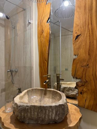 a bathroom with a large stone tub on a counter at The One Apartments in Siófok