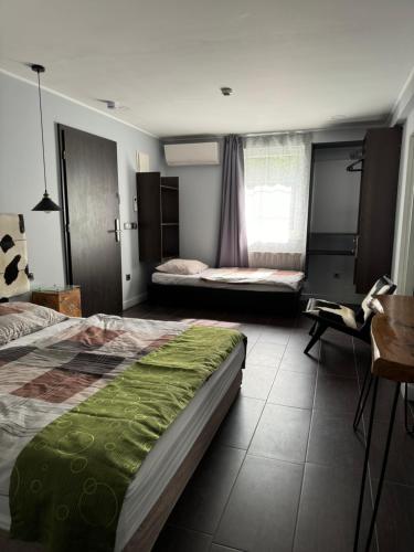 a hotel room with two beds and a desk and a desk at The One Apartments in Siófok