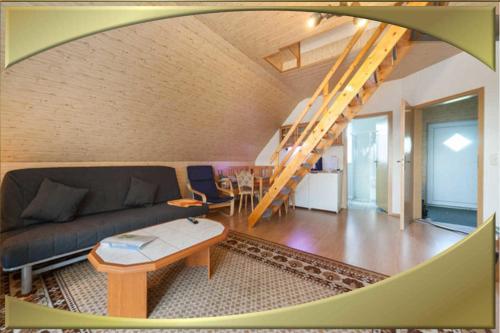 a living room with a couch and a table at Appartment1 in Waldidylle
