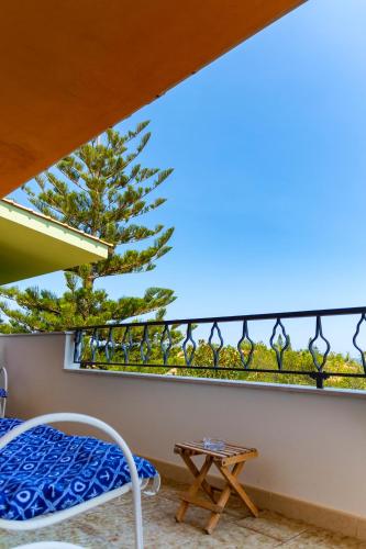 a bedroom with a balcony with a bed and a table at Nice to stay in Fontane Bianche