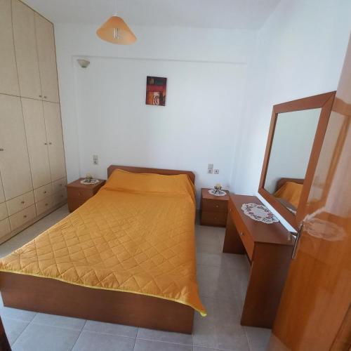 a small bedroom with a bed and a mirror at Central Rooms in Makry Gialos