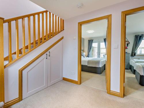 a room with a staircase and a bedroom with a bed at 2 Bed in Castle Douglas 59638 in Castle Douglas