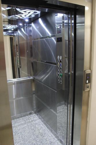 an elevator in a building with a glass door at Magnolia Apartment in Skopje