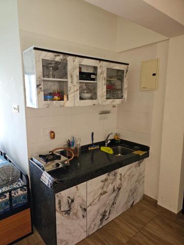 a kitchen with a sink and a counter top at Ratnaparkhi's Villa in Dapoli
