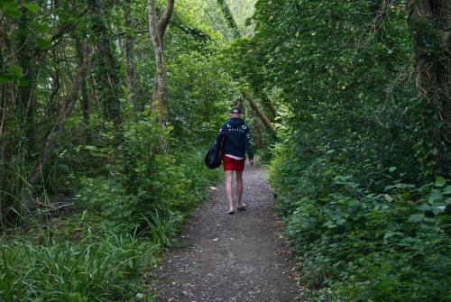 a person walking down a trail in the woods at Castle Archdale Holiday Park in Enniskillen