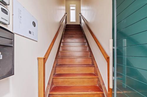 a staircase in a house with wooden floors at A ver o mar rooms - Santa Cruz city center in Santa Cruz