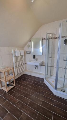 a bathroom with a shower and a sink at Akzent Hotel Strandhalle in Schleswig