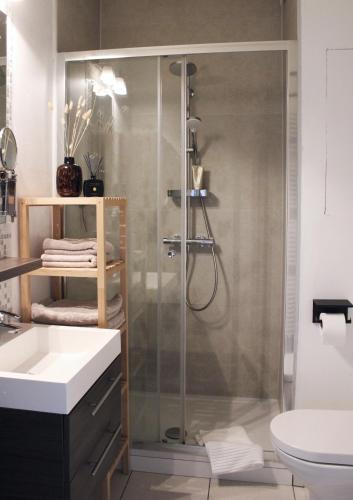 a bathroom with a shower and a sink at Sunny Apartment - Zuid Retreat 1BR Apartment near Scheldt River in Antwerp