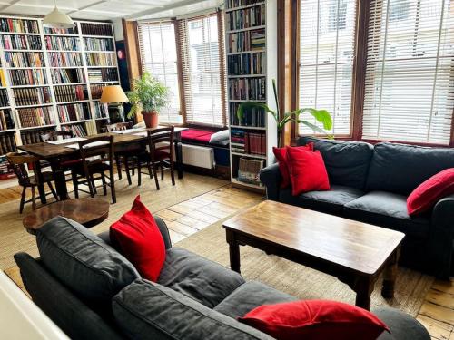 a living room with couches and red pillows at Hanushka in Hastings