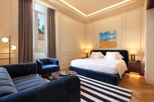 a hotel room with a bed and a couch at The First Arte - Preferred Hotels & Resorts in Rome