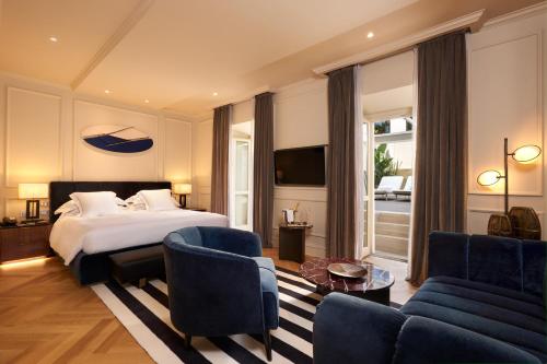 a hotel room with a bed and a living room at The First Arte - Preferred Hotels & Resorts in Rome