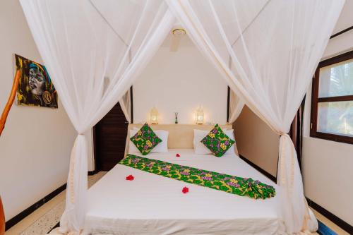 a bedroom with a bed in a tent at Daima Villas in Jambiani
