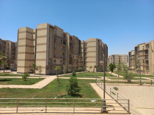 a park in front of some tall buildings at Apartment in 6 October city in 6th Of October