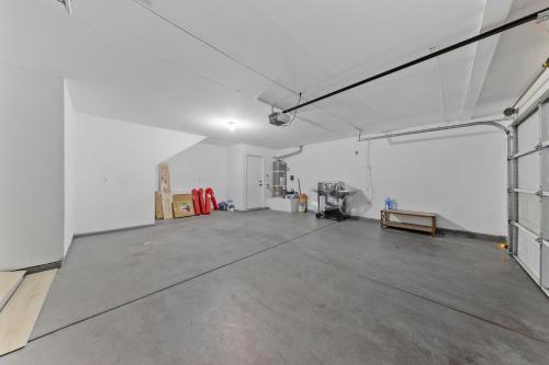 an empty garage with a concrete floor and white walls at ZEN - A home away from home and in HEART of Las Vegas in Las Vegas