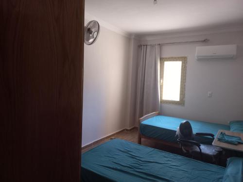 a small room with two beds and a window at Apartment in 6 October city in 6th Of October