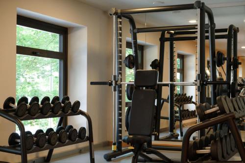 a gym with tread machines and a window at The Artist Grand Hotel of Art in Bilbao