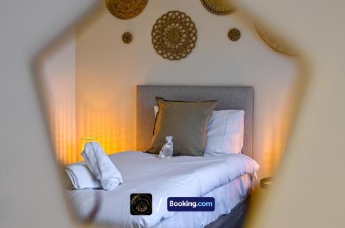 a bedroom with a bed with white sheets and pillows at Cosy 4-Bed House l Garden l Free Parking l WiFi l Specious l Hosted by The Cosy Corner Nationwide in Manchester