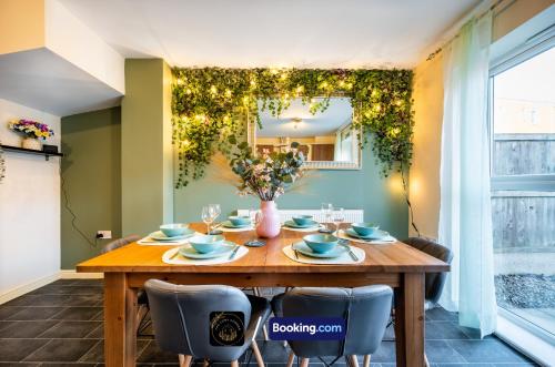 a dining room with a wooden table and chairs at Cosy 4-Bed House l Garden l Free Parking l WiFi l Specious l Hosted by The Cosy Corner Nationwide in Manchester