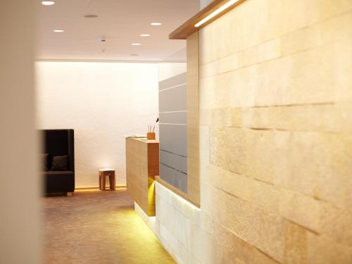 a hallway with a brick wall and a table at Hotel Nepomuk in Bamberg