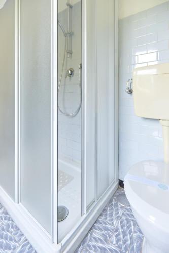 a bathroom with a shower and a toilet at Villa di paese - Splendida vista lago Maggiore in Oggebbio
