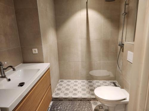 a bathroom with a toilet and a sink at Majestic in De Panne
