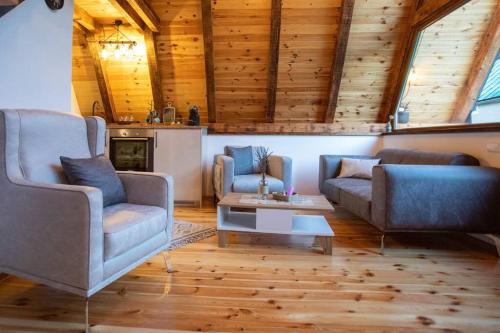 a living room with two chairs and a table at Boricje Village Escape in Pluzine