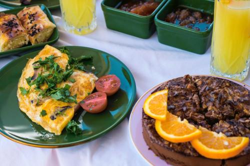 a table topped with plates of food with breakfast foods at cunda mor limon otel in Ayvalık