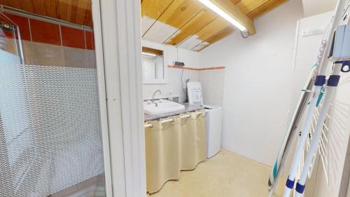 a bathroom with a sink and a washing machine at Fleur de Sel in Saint-Gilles-Croix-de-Vie