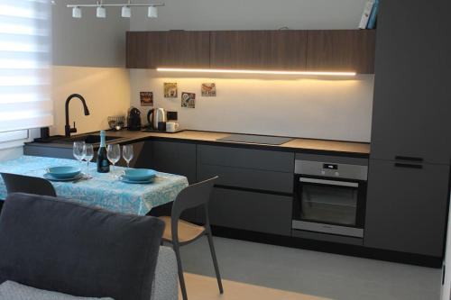 a kitchen with a table and a kitchen with a sink at Il Nido Guest House in Piacenza