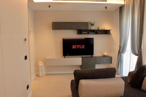 a living room with a flat screen tv on a wall at Il Nido Guest House in Piacenza