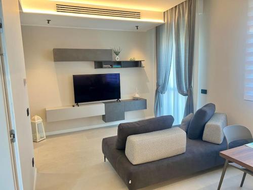 a living room with a couch and a flat screen tv at Il Nido Guest House in Piacenza