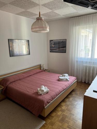 a bedroom with a bed with two towels on it at Guesthouse48 in Bolzano