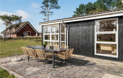 a black house with a black table and chairs at Three-Bedroom Holiday Home In Millinge in Millinge