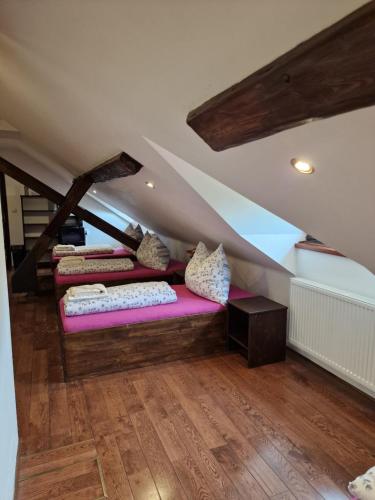 a room with three beds in the attic at Vlčí Jámy in Lenora