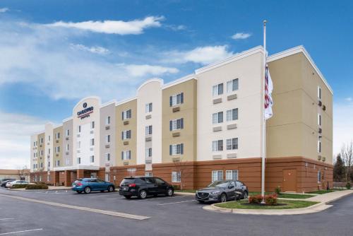a hotel with cars parked in a parking lot at Candlewood Suites Paducah by IHG in Paducah