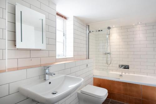 a white bathroom with a sink and a toilet at The Berkeley Square Hotel Bristol in Bristol