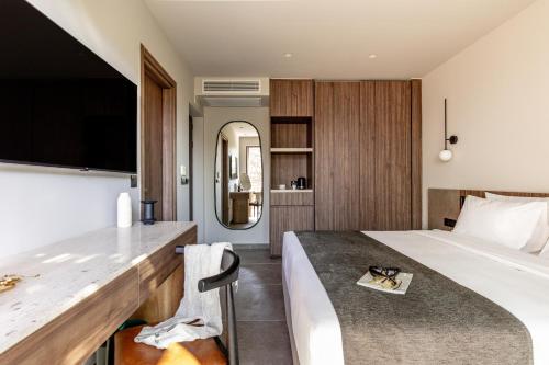 a hotel room with a bed and a mirror at Elios Hill in Hersonissos