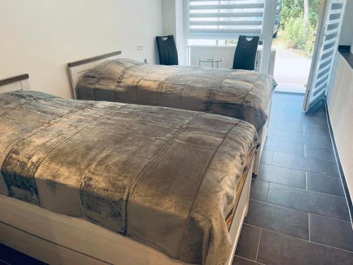 Una cama o camas en una habitación de Waldstadt Homes, Iserlohn