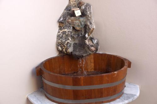 a statue of a rock sitting in a barrel at Rock Garden E28 Pool villa in Mae Pim