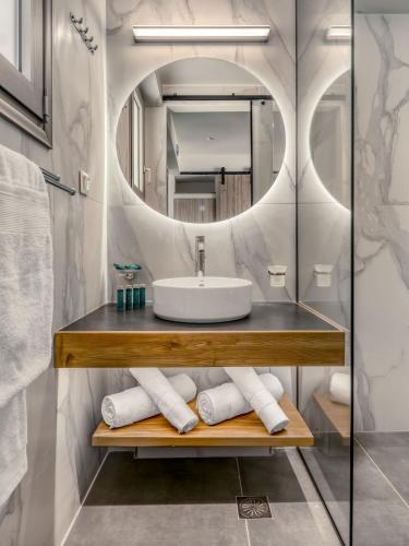 a bathroom with a sink and a mirror at Gaia luxury loft in Skiros