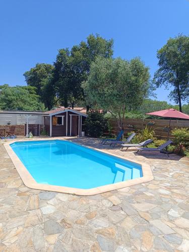 une piscine avec de l'eau bleue dans une cour dans l'établissement Villa Naturéa, à Messanges